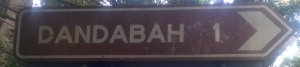 Brown sign for Dandabah, 1km