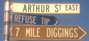 Brown sign for 7 Mile Diggings, white sign for Arthur St East, blue sign for Refuse Tip