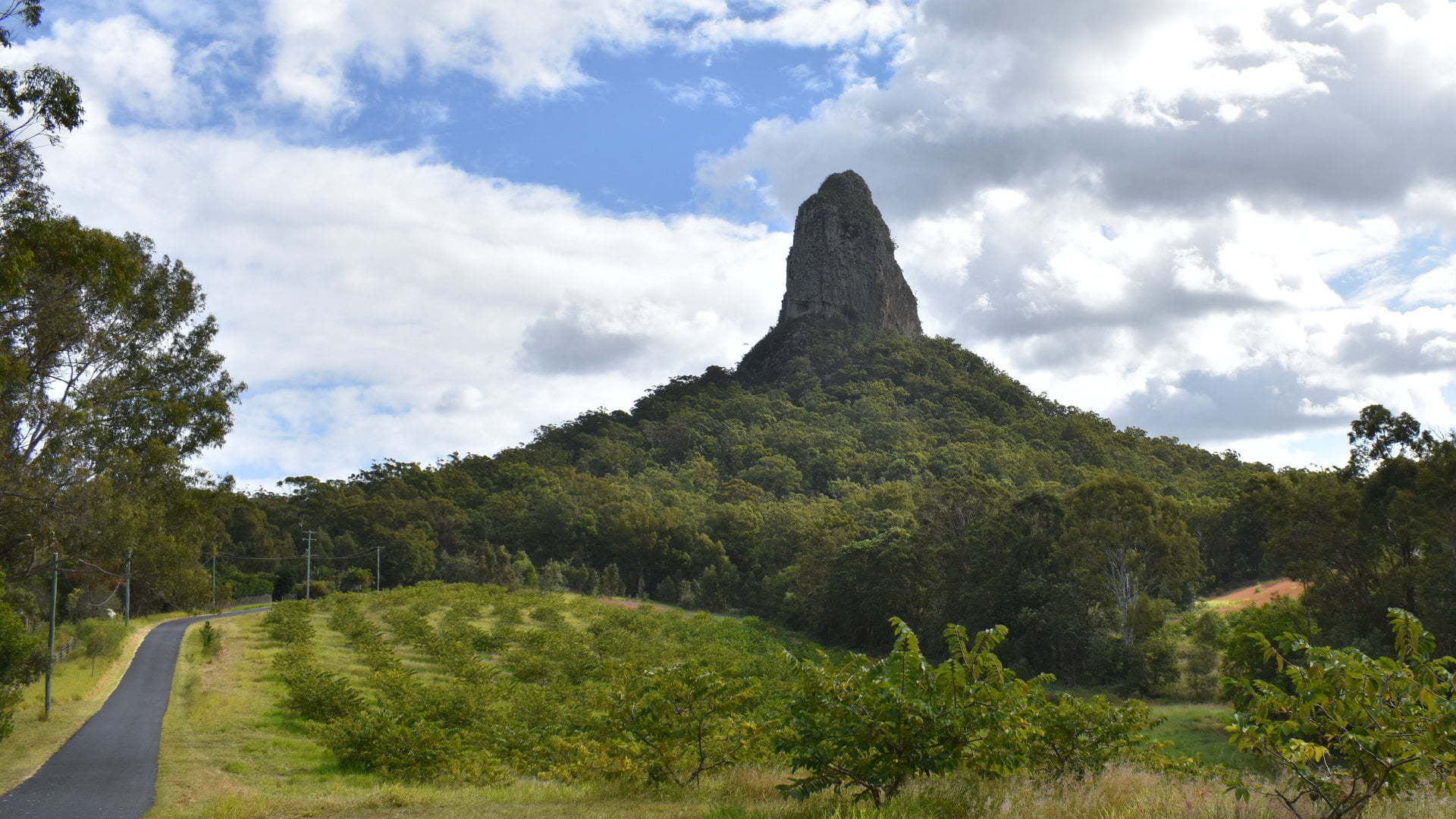 View of Mt Coonowrin, one of the peaks forming the Glass House Mountains. The area is closed from public access, the viewing point provides space to view Mt Coonowrin