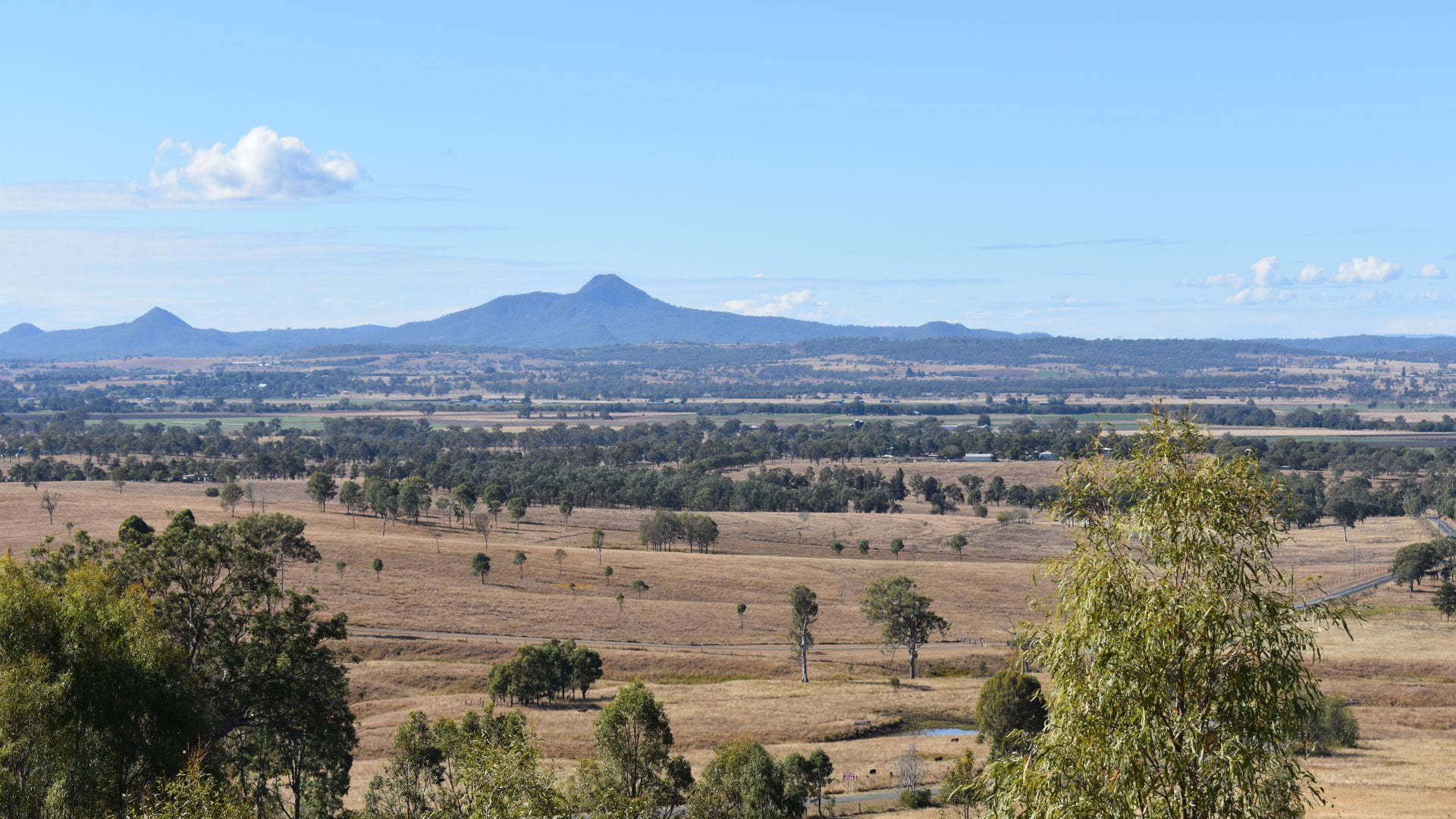 View looking east from Cunningham Lookout, a raised ridge 3km west of Warrill View, with views over the surrounding flat plains and the mountains to the east and west