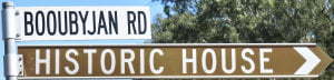 Brown sign for Historic House, sign for Booubyjan Rd
