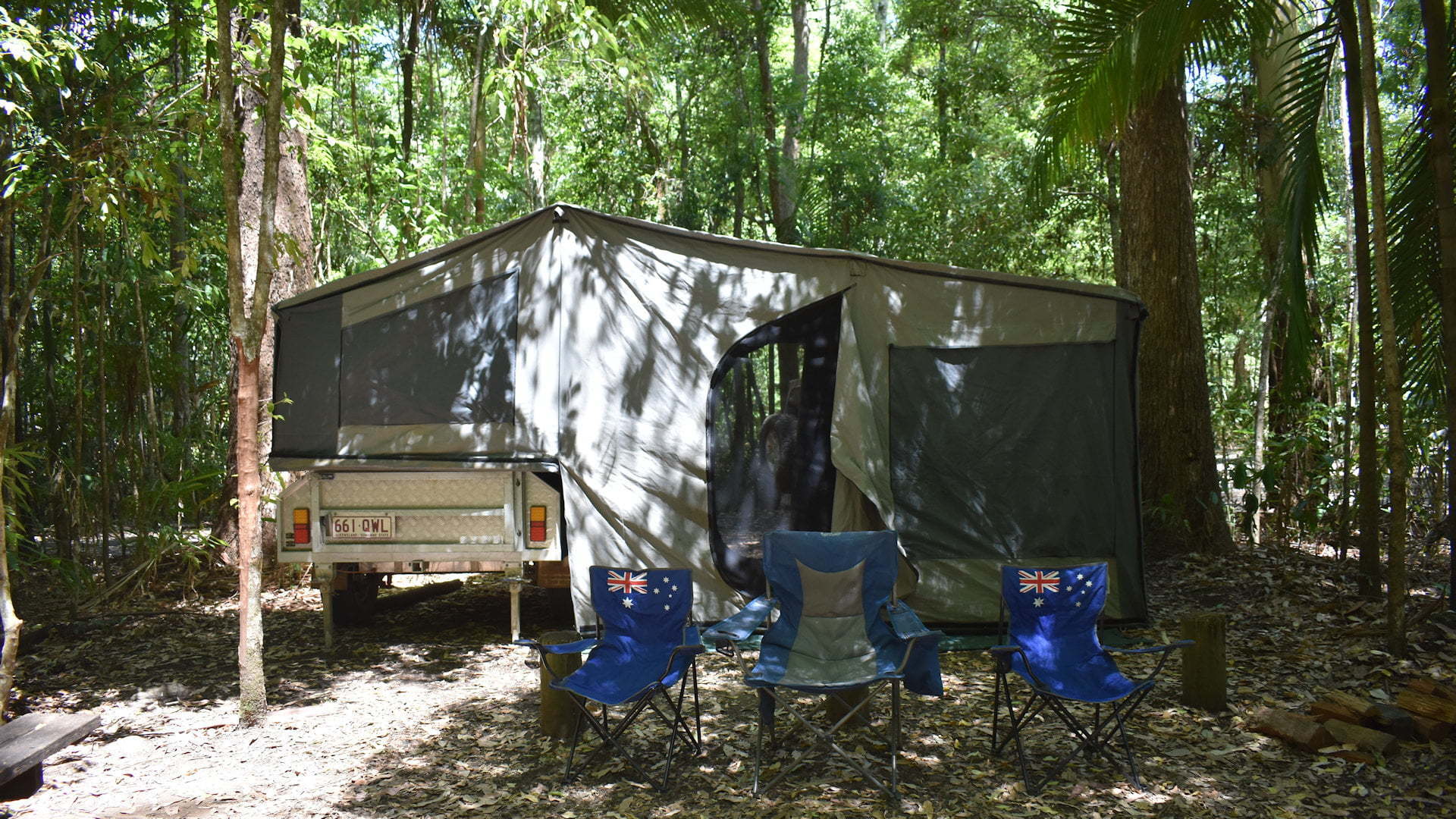 Camper trailer and camp chairs at Iron Pot Creek campground in Toonumbar National Park