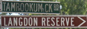 Brown sign for Langdon Reserve, grean sign for Tamrookum Ck Rd
