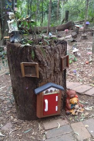 Tree stump made into a fairy house with windows and door, taken at the Fairytale Trail in Kumbartcho Sanctuary