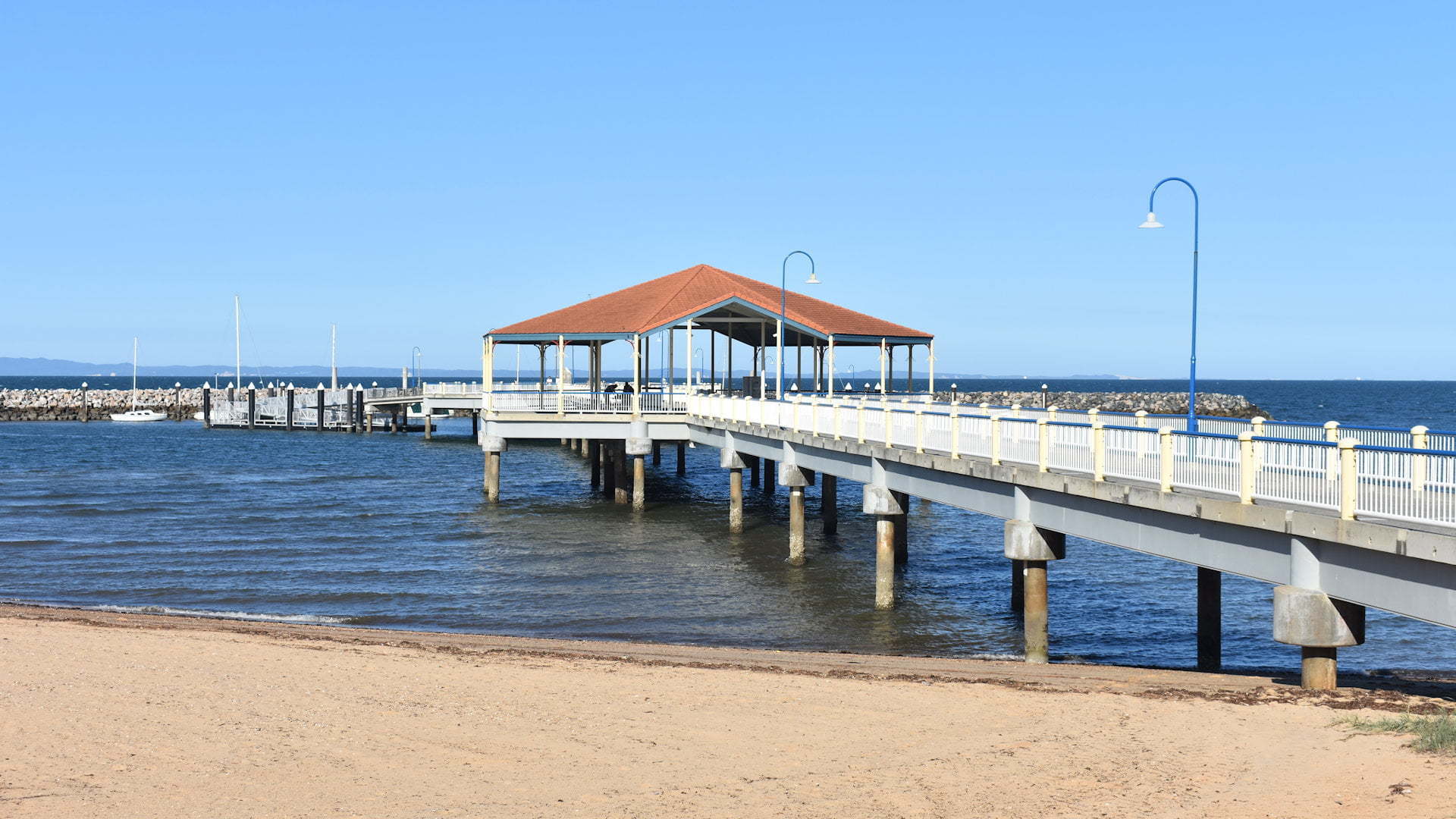 Jetty out from the beach with a rotunda part way along, taken from the sand at Redcliffe Jetty