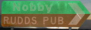 Brown sign for Rudds Pub, green sign for Nobby