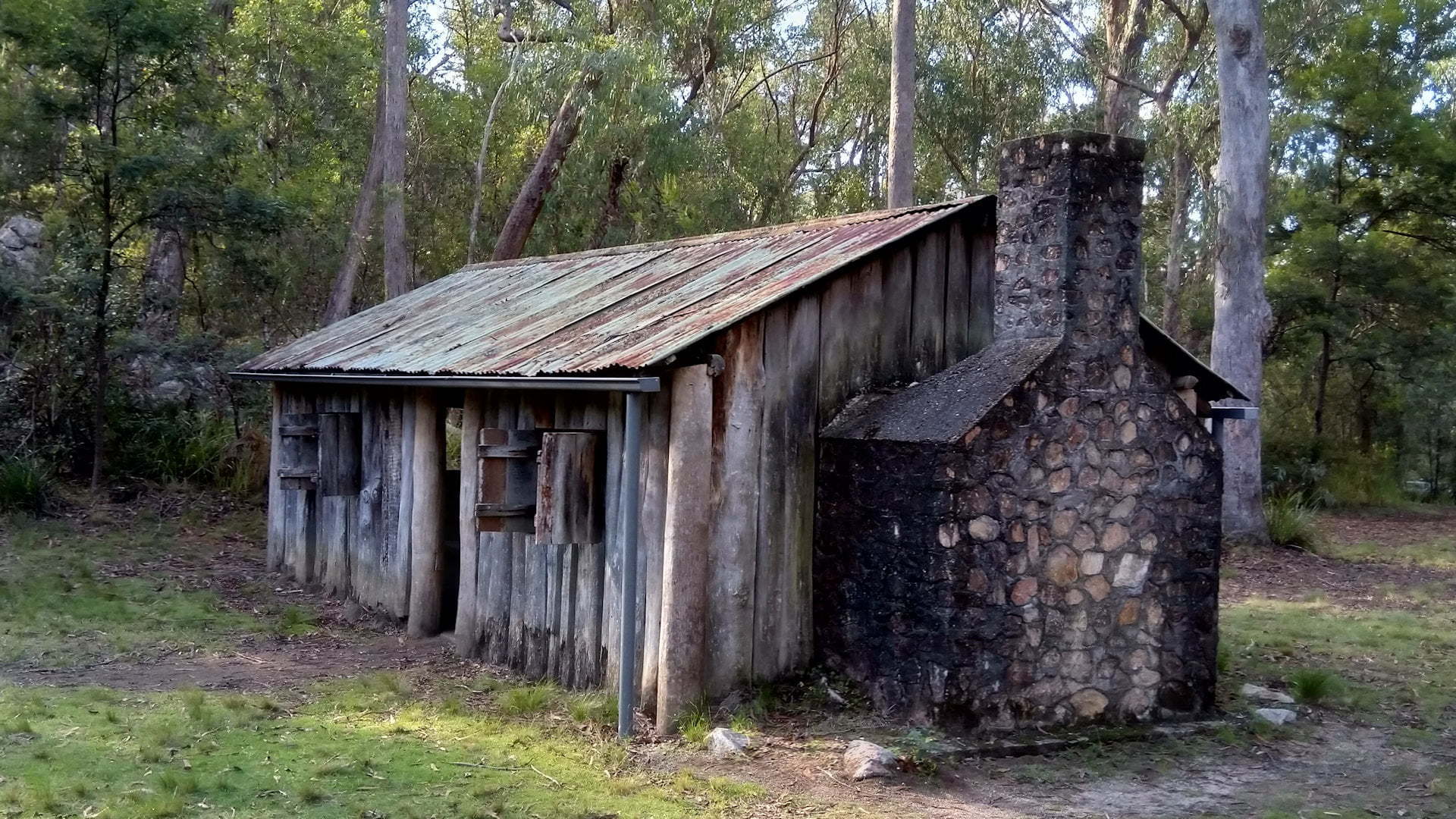 Slab hut with iron roof and stone fireplace and chimney on the end, taken of Mulligan's Hut in Gibraltar Range National Park