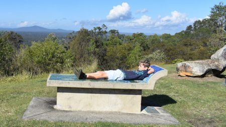Boy on a mosaic tiled concrete seat with a view, taken at the Maclean Lookout