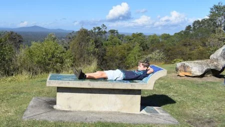 Boy on a mosaic tiled concrete seat with a view, taken at the Maclean Lookout