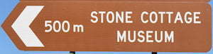 Brown sign for Stone Cottage Museum, 500m