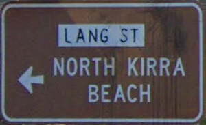 Brown sign for North Kirra Beach, white sign for Lang St