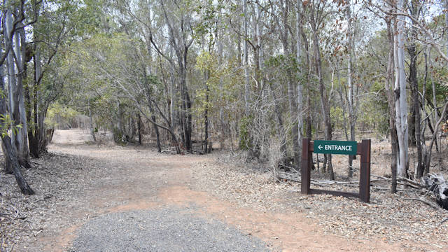 Walking trail with a sign showing the entrance