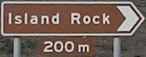 Brown sign for Island Rock, 200m