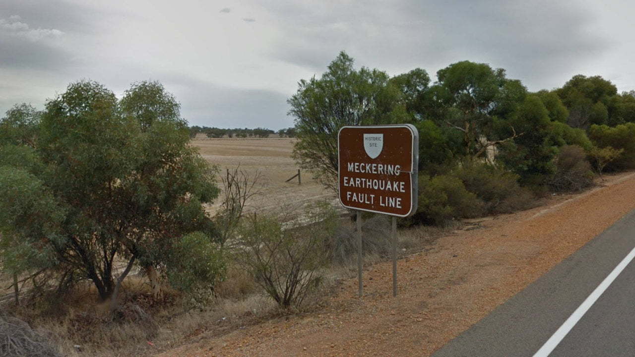 Historic site of the Meckering Earthquake Fault Line, a brown sign on the side of the road along the Great Eastern Highway in Western Australia, west of the town of Meckering