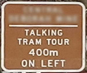 Brown sign for Talking Tram Tour, 400m on left