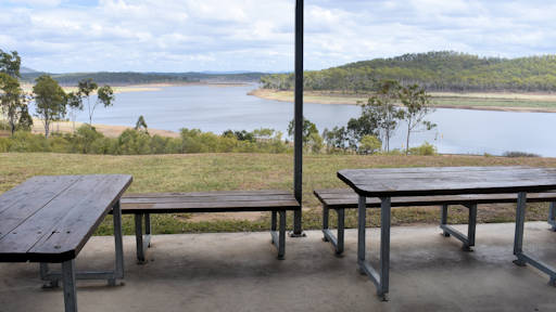 Sheltered picnic tables with views over the water of Paradise Dam