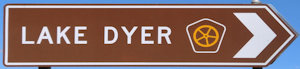 Brown sign for Lake Dyer, with the Cobb & Co tourist drive symbol