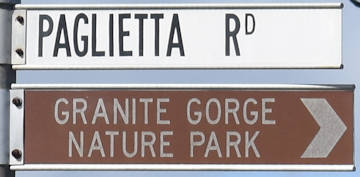 Brown sign for Granite Gorge Nature Park, white sign for Paglietta Rd