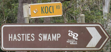 Brown sign for Hasties Swamp, yellow sign for Koci Rd