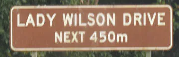 Brown sign for Lady Wilson Drive, Next 450m