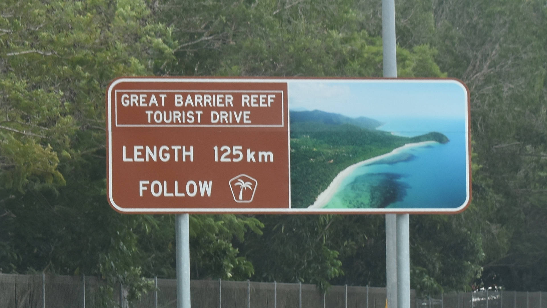 Brown sign for Great Barrier Reef Tourist Drive, length 125km, follow palm tree symbol