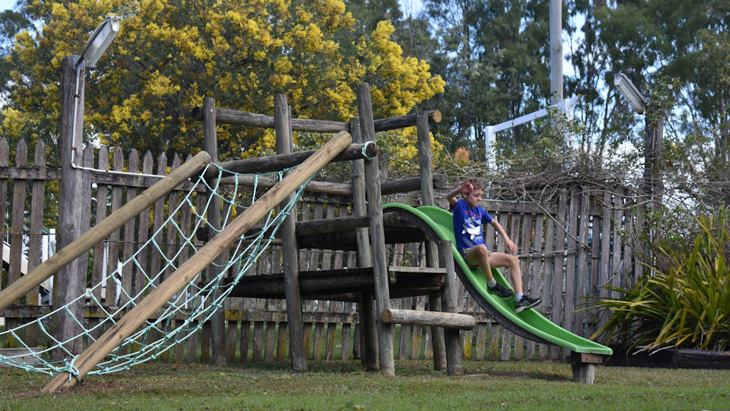 Wooden fort playground with slide