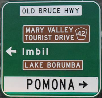 Brown sign for Lake Borumba and Mary Valley Tourist Drive 42, green sign for Imbil, white sign for Pomona and Old Bruce Hwy