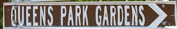 Brown sign for Queens Park Gardens