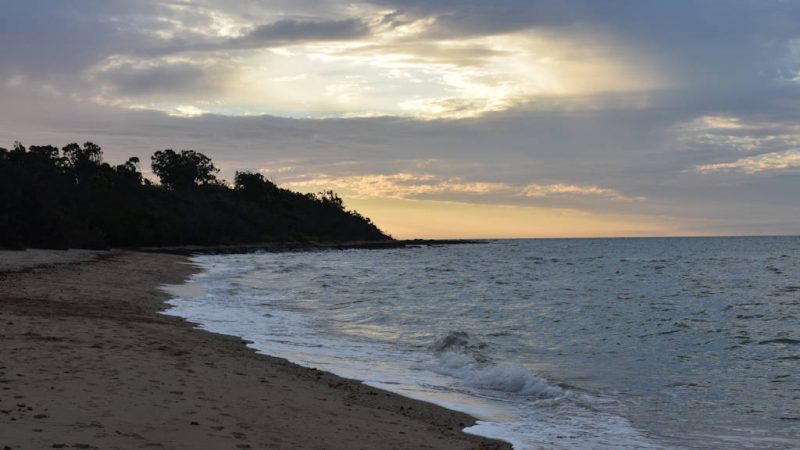 Late afternoon beach, overcast sky with light coming through the clouds in the distance, taken at Esa Park in Hervey Bay