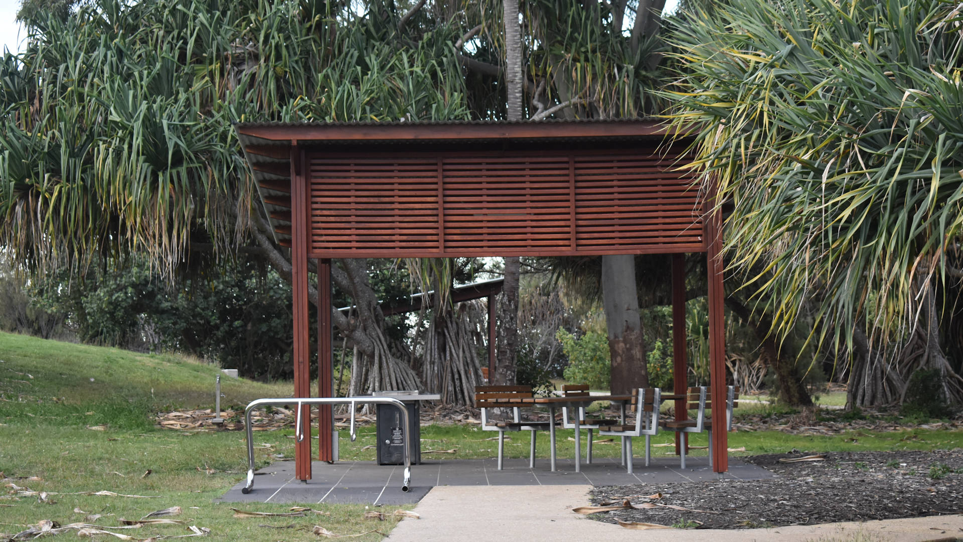 Sheltered picnic table and BBQ in a park, taken at The Gables at Point Vernon in Hervey Bay