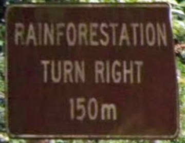 Brown sign for Rainforestation, turn right, 150m