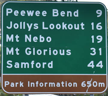 Brown sign for Park Information, green sign for Peewee Bend, Jolly Lookout, Mt Nebo, Mt Glorious, Samford