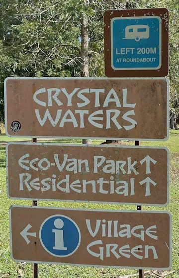 Brown sign for Crystal Waters, Eco-Van Park, Village Green