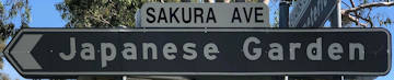 Brown sign for Japanese Garden, white sign for Sakura Ave