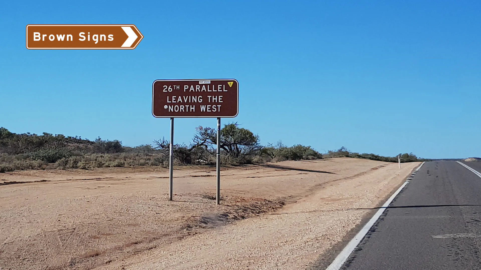 Brown sign at the 26th Parallel on the edge of the North West region in Western Australia